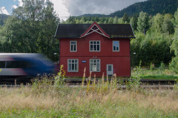 Image may contain: Rural area, Cottage, Rail transport, Track, Train.